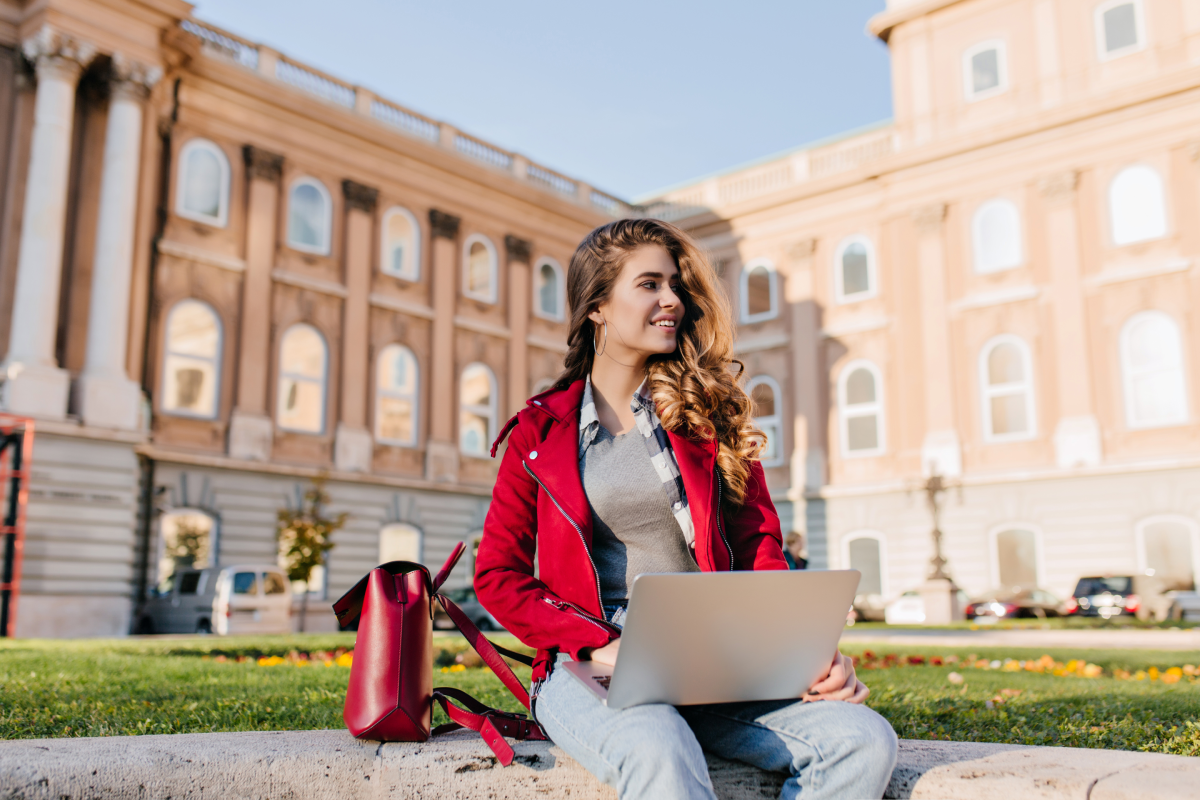 interested-dark-haired-girl-wears-casual-attire-chilling-park-near-university-using-laptop